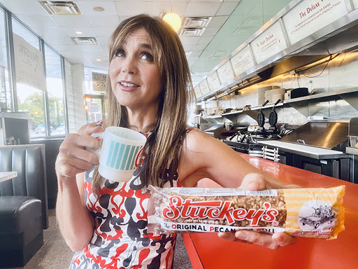 Stephanie Stuckey offering a Pecan Log Roll promotional advertising picture