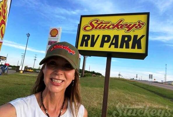 Stephanie Stuckey in front of a Stuckey's Oklahoma Sign promotional advertising picture