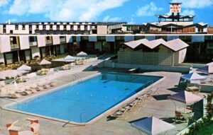Postcard with two images. Top image shows exterior view of Air Host Inn. Second image shows outdoor swimming pool at Air Host Inn.