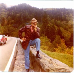 Picture of Archie Campbell standing alongside of the road and smoking on of his trademark cigars sometime around 1977.