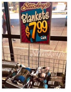 Photo of falsa blankets with cardstock sign advertising them for sale at $7.99 ea at the Stuckey's Express in Heidelberg, Mississippi.