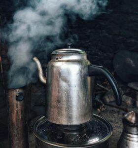 Picture of a coffee pot with steam coming out of it.