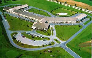 Postcard of and artist's rendering of an aerial view of the Hershey Lodge around 1967.